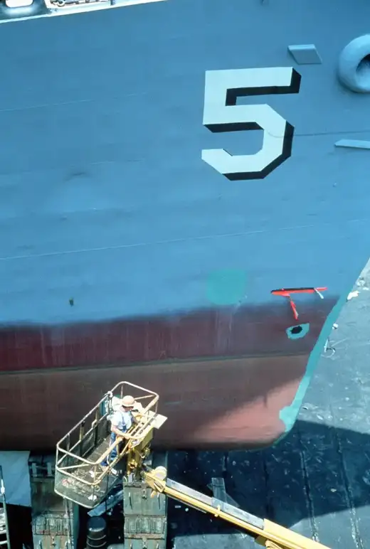 Destroyer in dry dock during hull maintenance for ship repair coatings Duqm