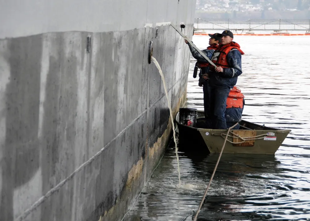 Marine topcoats and finishes applied to a ship hull by a sailor