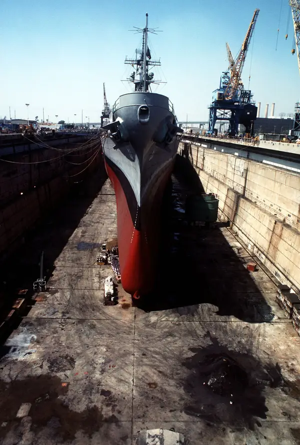 Ship in dry dock during hull painting, an example of a marine coating system in use