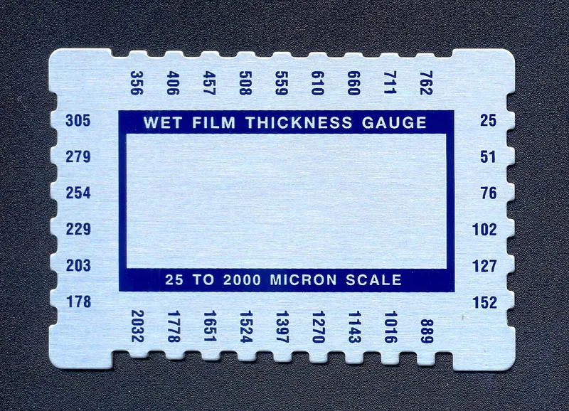 Wet film thickness gauge comb card used to check marine coating DFT while paint is wet