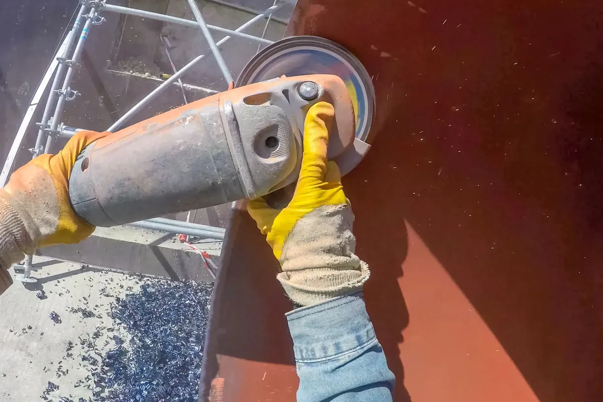 Marine coating surface preparation: removing old coating from steel with a power tool