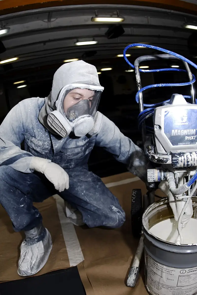 Stirring paint to check marine paint shelf life before application
