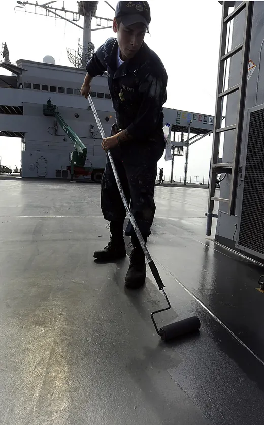 Roller painting a ship main deck in humid conditions
