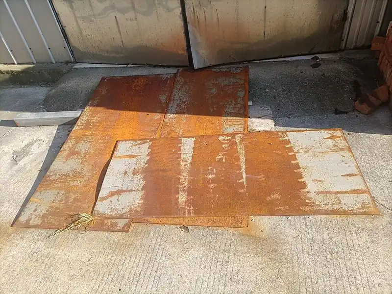 Rusty steel plate showing flash rust on corroded steel surface